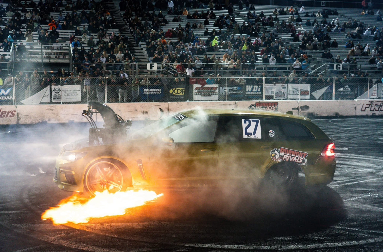 car performing burnout shooting flames from boom tube